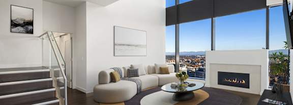 A modern living room with a fireplace and a view of Bellevue at Two Lincoln Tower.