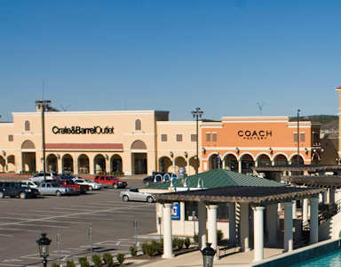 A shopping center with a pool in the middle.