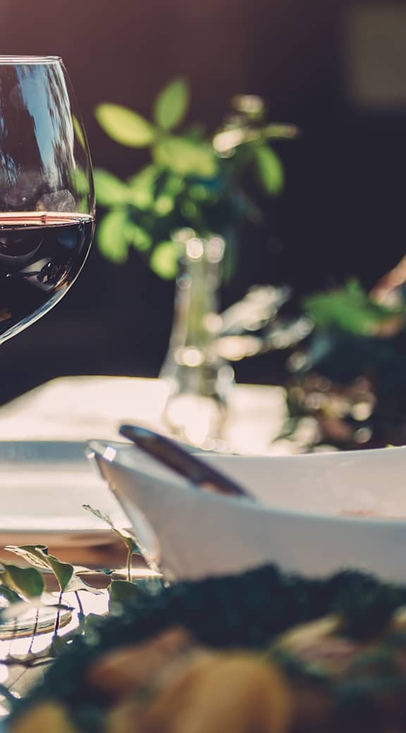 A table set for a meal with wine glasses and plates. at Aero White Rock, Dallas, 75238