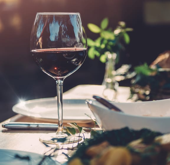 a table with glasses of wine on it at The Broadwater at Salado Creek, San Antonio, Texas