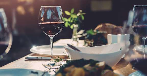 a table with a glass of wine and a bowl of food  at The Frederick, San Antonio, TX, 78240