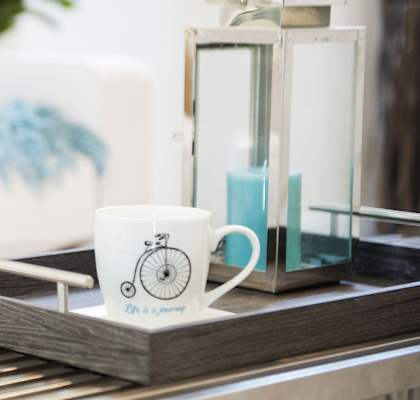 a coffee table with a book and glasses on it