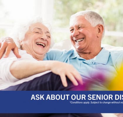 ask about our senior discount code for an older man and woman sitting on a couch