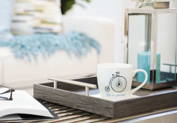 a coffee table with a book and glasses on it