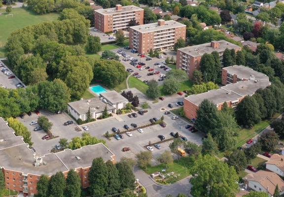 arial view of a building with a pool in the middle of a parking lot