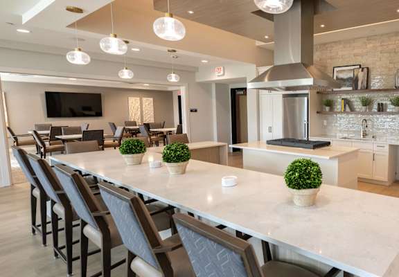 a large kitchen with a long island with chairs