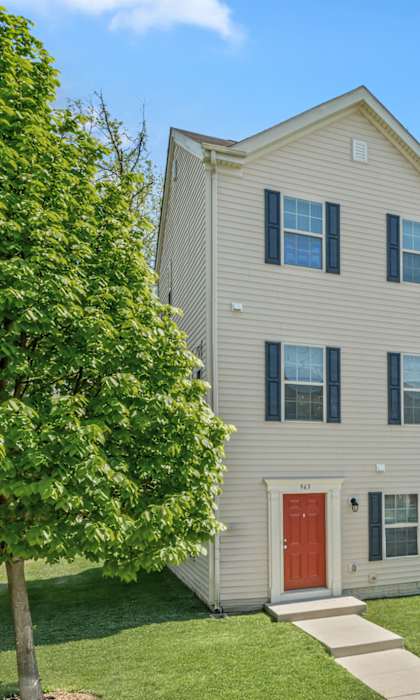 A row of townhouses with trees in front of them.