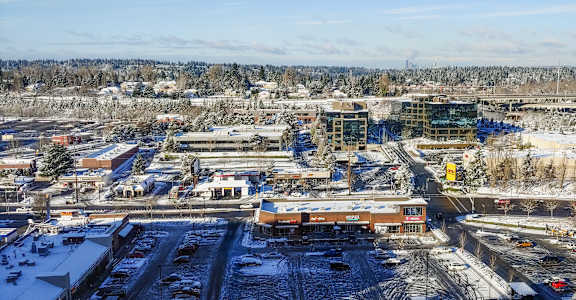A view of a parking lot and buildings from above.