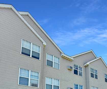 A large apartment building with multiple windows and balconies.