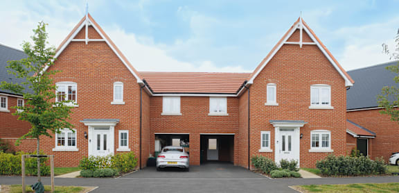 A red brick house with a white garage door.