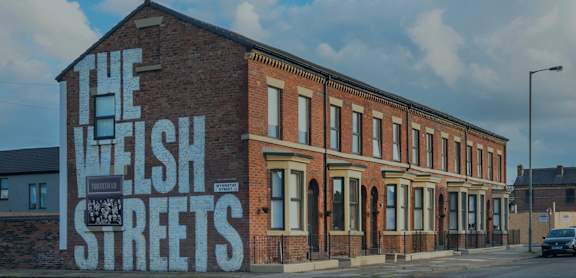 A red brick building with a sign that says Welsh Streets.