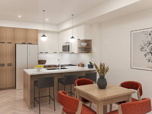 A modern kitchen with a dining table and chairs.