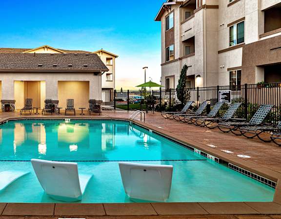 First and Main Apartments resort-style pool area with surrounding sundeck