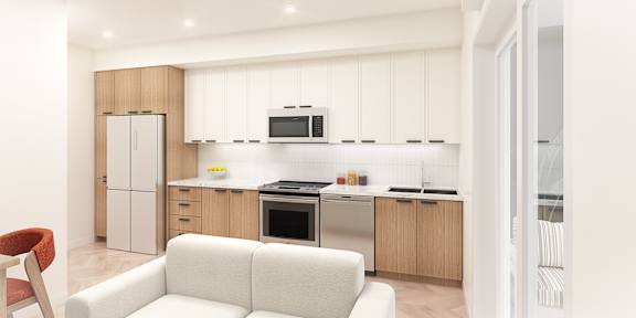 A modern kitchen with a white couch and wooden cabinets.
