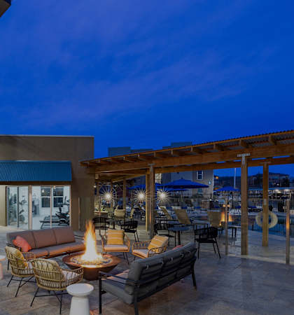 Poolside fire pit lounge area - ABQ Uptown Apartments