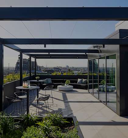a terrace with chairs and tables and a view of the city