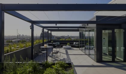 a terrace with chairs and tables and a view of the city