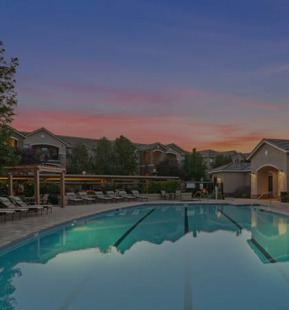 Lighted pool at dusk - Mountain Shadows Apartments