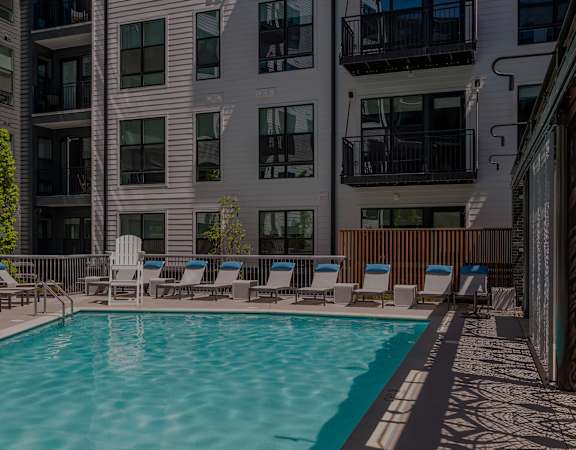 Swimming pool with surrounding lounge chairs - Rockwell at Crown