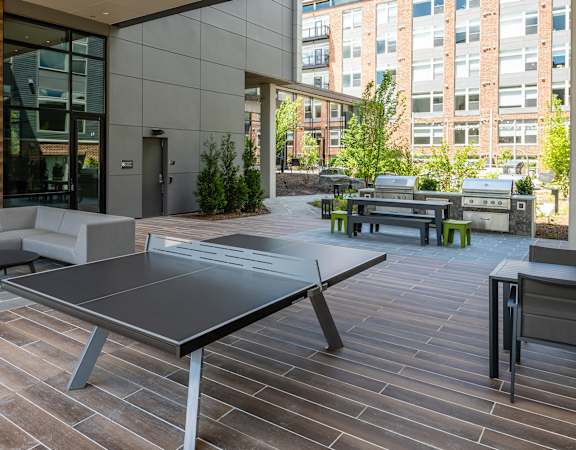 Outdoor lounge with fireplace, ping pong and grilling stations - Brentford at the Mile