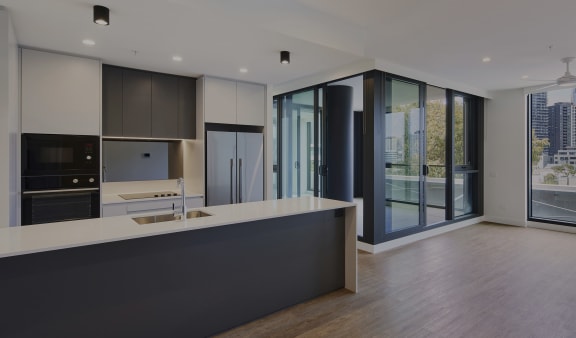 a kitchen with a large counter top and a large window