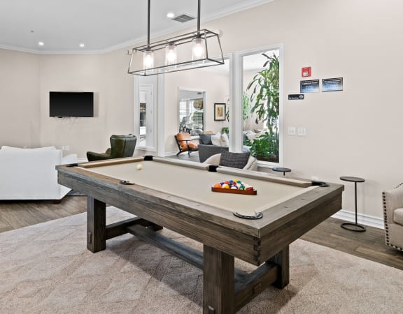 Game room with billiards table and widescreen tv - Mountain Shadows Apartments