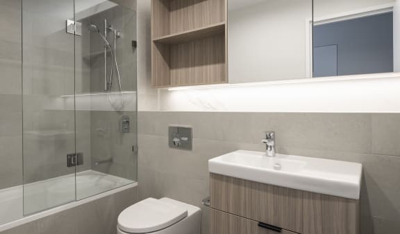 a renovated bathroom with a shower sink and toilet