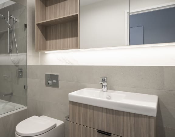 a renovated bathroom with a shower sink and toilet