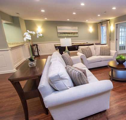 a living room with couches and chairs and a fireplace