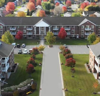 an aerial view of an apartment complex in the fall
