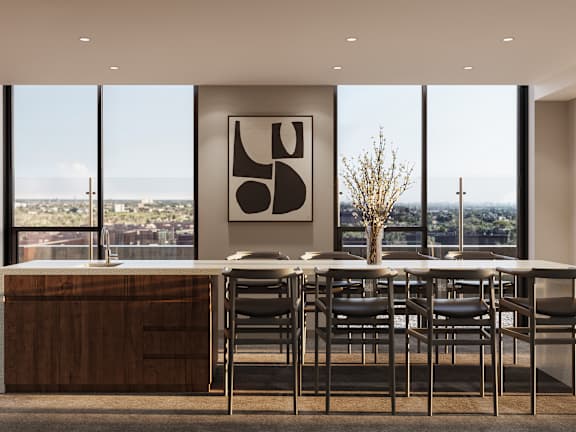A modern kitchen with a dining table and chairs.
