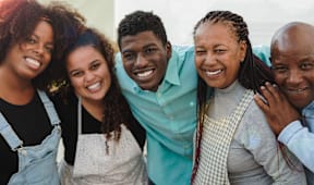 a group of people smiling and posing for a picture