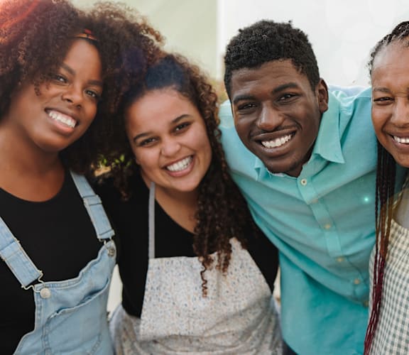 a group of people smiling and posing for a pictureat Coach House Apartments, Missouri