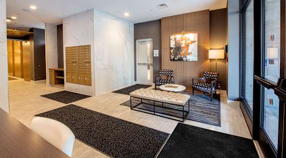 a lobby with a seating area and a table