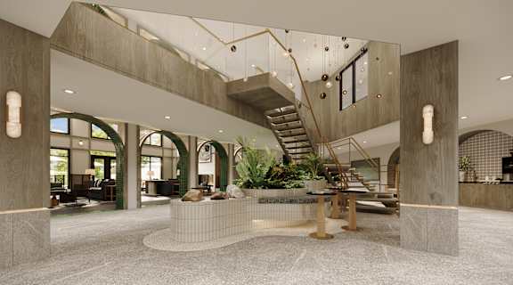 A modern interior space with a staircase, seating area, and a large window.