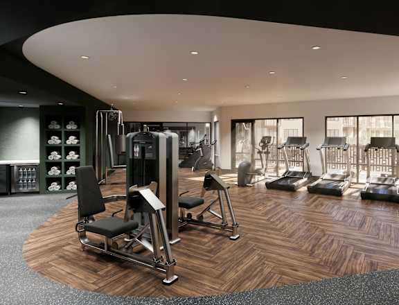 A gym with a variety of equipment including treadmills, weights, and exercise machines.