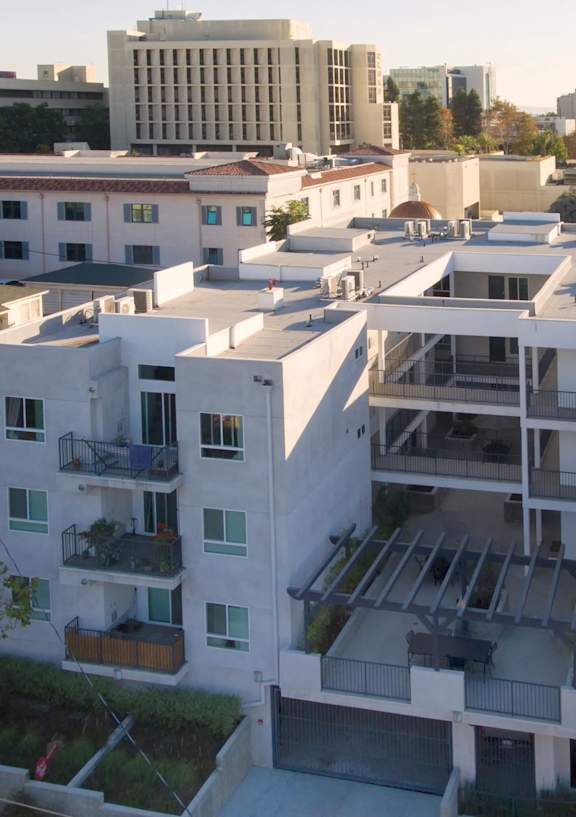 A modern apartment complex with a mix of white and grey buildings at Valley Street Apartment, Los Angeles, CA, 90057