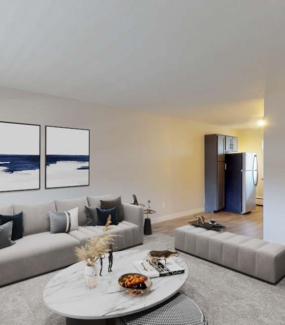 A modern living room with a grey sofa, a white coffee table, and a painting on the wall.