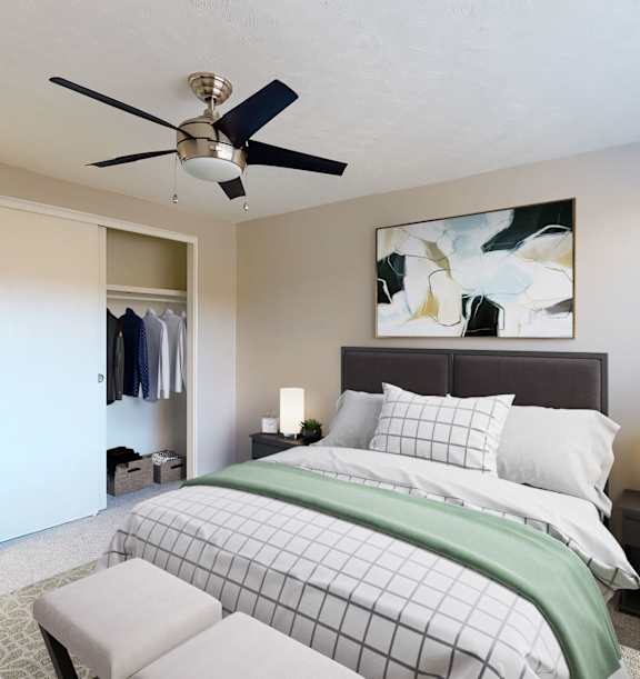 A bedroom with a bed, a ceiling fan, and a painting on the wall.