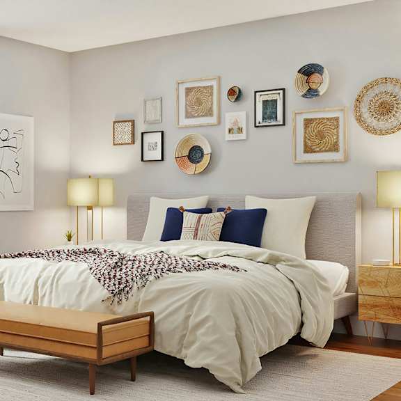 A bedroom with a large bed and a wooden bench.