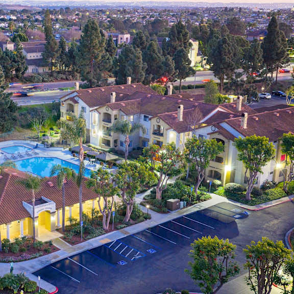 A large building with a pool in the middle of a parking lot.