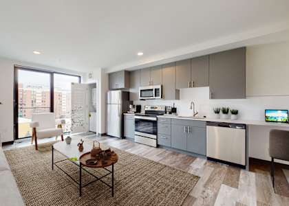 A modern kitchen with a dining table and chairs in the middle of the room.