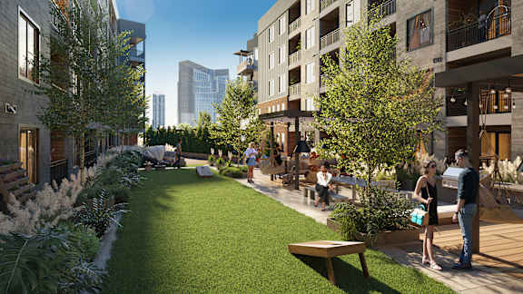 a rendering of a grassy courtyard with people and buildings