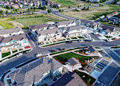 Thumbnail 7 of 8 - an aerial view of a neighborhood of houses with cars parked on the street