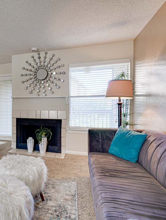 A living room with a fireplace, a couch, and a television.