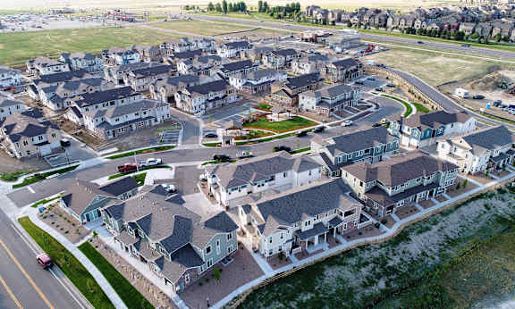 an aerial view of a large residential neighborhood with cars parked in it