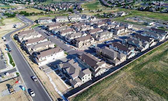 an aerial view of a neighborhood with houses and a road
