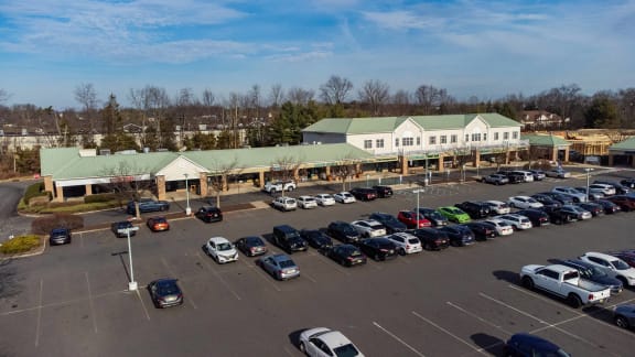 a parking lot full of cars in front of a building