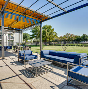 a covered patio with blue couches and a fire pit  at Highland Luxury Living, Lewisville, TX, 75067
