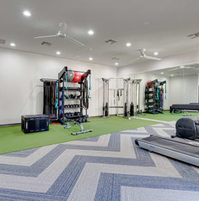 Gym with treadmills at the enclave at woodbridge apartments in  at Limestone Ranch, Texas